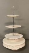 A White ceramic cake stand with pierced floral detail