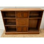 A sideboard with central cupboards and drawers flanked to both sides by three shelves.(H 84cm x W