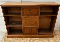 A sideboard with central cupboards and drawers flanked to both sides by three shelves.(H 84cm x W