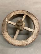 A vintage wooden four spoke wheel barrow wheel with metal rim