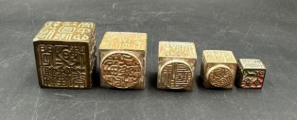 A set of five Chinese brass stacking seals