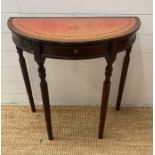 A Demi Lune mahogany side table with red leather top (H72cm W76cm D38cm)