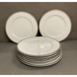 A set of eight LSA dinner plates