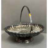 A silver plate scalloped handled tray of muffin dish on a footed base