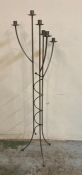 A six arm wrought iron floor standing candle holder