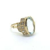 Oval aqua and diamond ring, the shoulders are decorated with 16 diamonds set into squares. 18