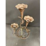 A white metal flower vase on stand