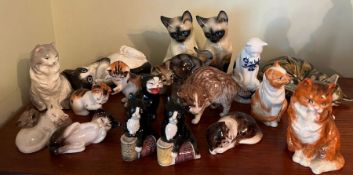 A selection of china cats various makers and ages including Royal Worcester, Royal Doulton etc