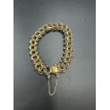 A gold plated bracelet marked 1/2012kgf