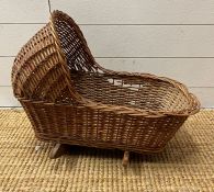 A child's wicker dolls cradle