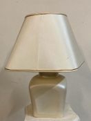 A cream rectangular ceramic based table lamp