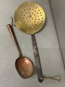 A brass and copper vintage slotted spoons