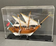 A cased model of a boat (H23cm W35cm D7cm)