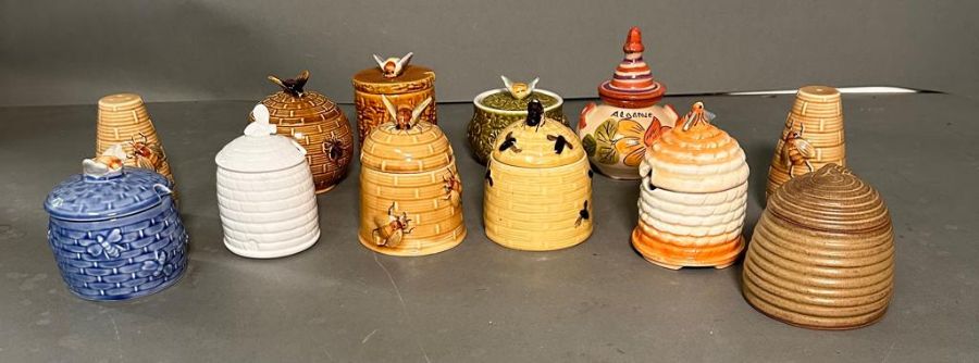 A collection of china honey pots and a salt and pepper shaker, various makers and marks