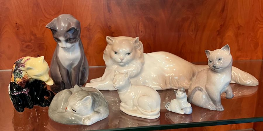 A selection of cat figures by Nao, Lladro and other makers