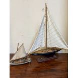 Two sailing boats, one on stand