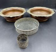 A small selection of white metal objects including a pair of Georgian wine coasters