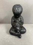 A black plaster bust of a boy with a rabbit by Austin Productions Inc