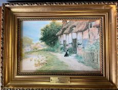 A cottage print in a gilt frame