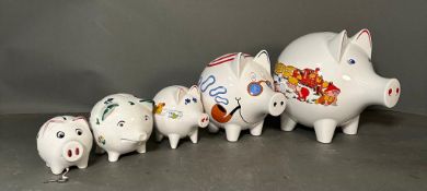 A selection of vintage white painted piggy banks. Various ages and sizes