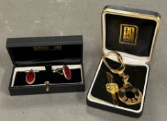 DAKs of London cuff links , along with keyring and tie pin.