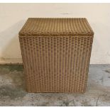 A gold painted wicker laundry basket