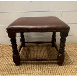 An oak brown faux leather upholstered on turned legs with cross stretcher (H31cm)