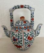 A double sided Chinese teapot with tree peonies decoration.