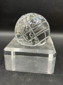 A Waterford crystal globe on an acrylic stand