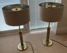 A pair of brass and chrome effect table lamps