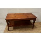 A pine stained coffee table with shelf under (H49cm W99cm D48cm)