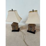 A pair of ceramic lamps on wooden bases