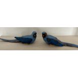 A pair of ceramic parrots