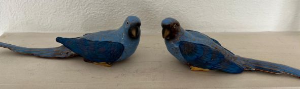 A pair of ceramic parrots