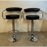 A pair of high back contemporary chrome bar stools, upholstered in faux black leather (H92cm)