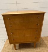 A teak Mid Century four drawer chest of drawers (H92cm W77cm D47cm)