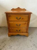 A pine Jaycee three drawer bedside table with a galleried top (H67cm W58cm D47cm)