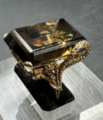 A 9ct gold smokey quartz ring in an ornate setting.