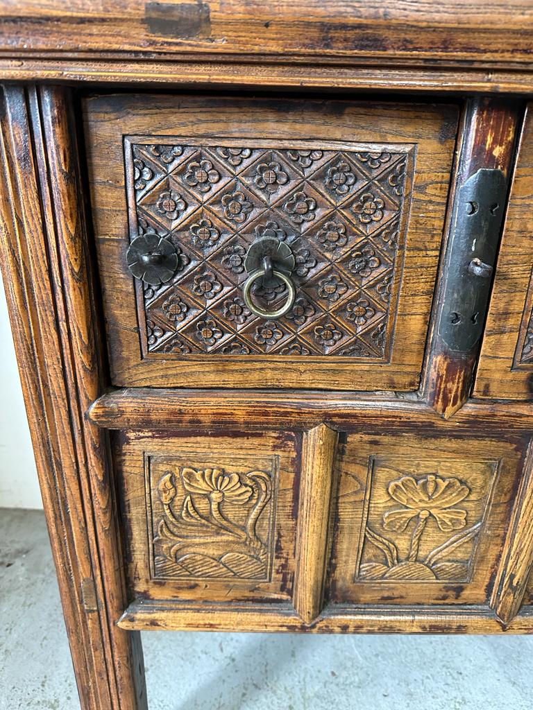 A vintage Burmese two drawer wine table with carved floral detail (H85cm W108cm D55cm) - Image 2 of 4