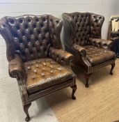 A pair of brown leather Chesterfield style wing back arm chairs (H107cm D68cm)
