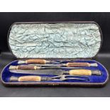 A cased carving set with silver mounts and horn handles