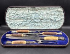 A cased carving set with silver mounts and horn handles