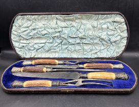 A cased carving set with silver mounts and horn handles
