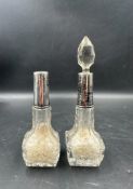 Two Art Deco cut glass perfume bottles with silver hallmarked collars, one with stopper one without