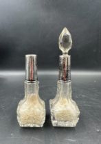 Two Art Deco cut glass perfume bottles with silver hallmarked collars, one with stopper one without