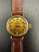 A Ladies 18ct gold Omega De Ville wristwatch, circular gold coloured dial, yellow faceted dot hourly