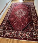 A red ground hand knotted wool carpet (3.45 m x 2.10 m)