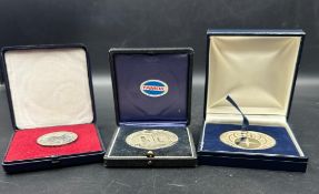 A selection of three boxed commemorative coins to include Citi bank Bahrain and Tamoil