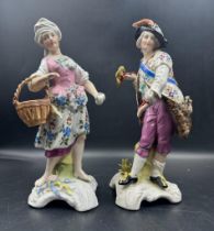 Two hand painted figurines in the manner of Dresden. A gentleman with a hawk and a lady with a