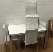 A contemporary white kitchen table on chrome legs with four matching chairs (Two AF and two as